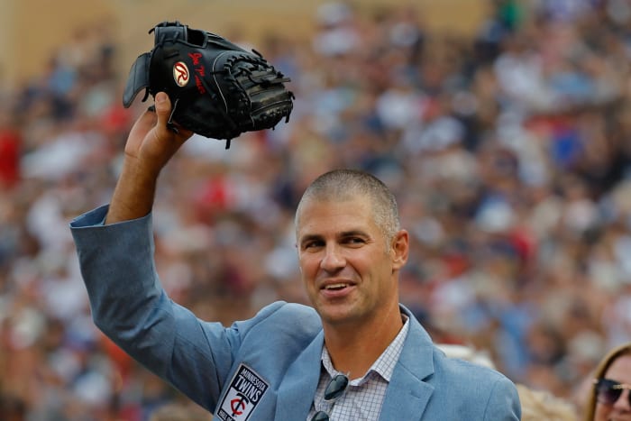Joe Mauer waves with mitt